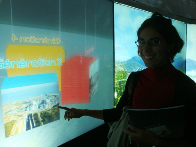 a women who is pointing at a projector screen