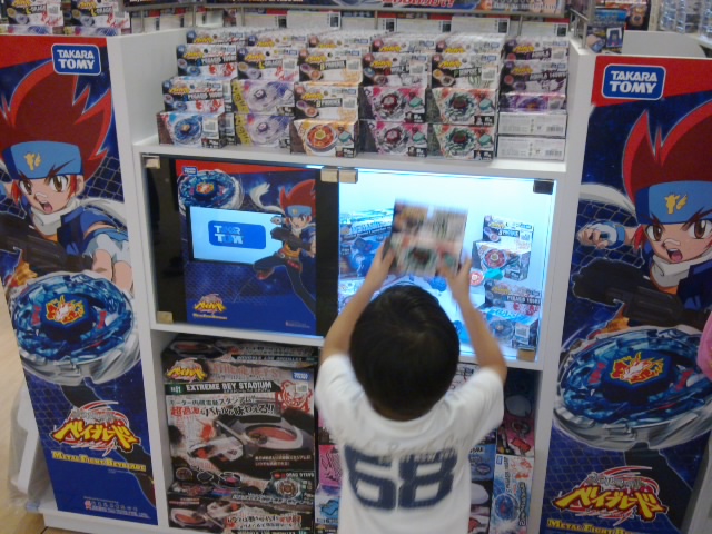 a boy playing video games in a store