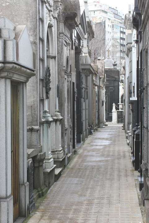 a man is walking down an alley in an old world city