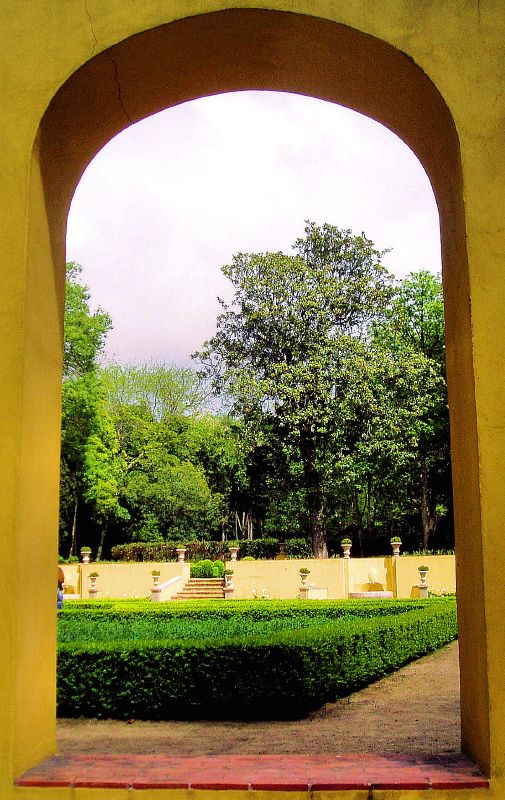 there is an archway that opens to a garden