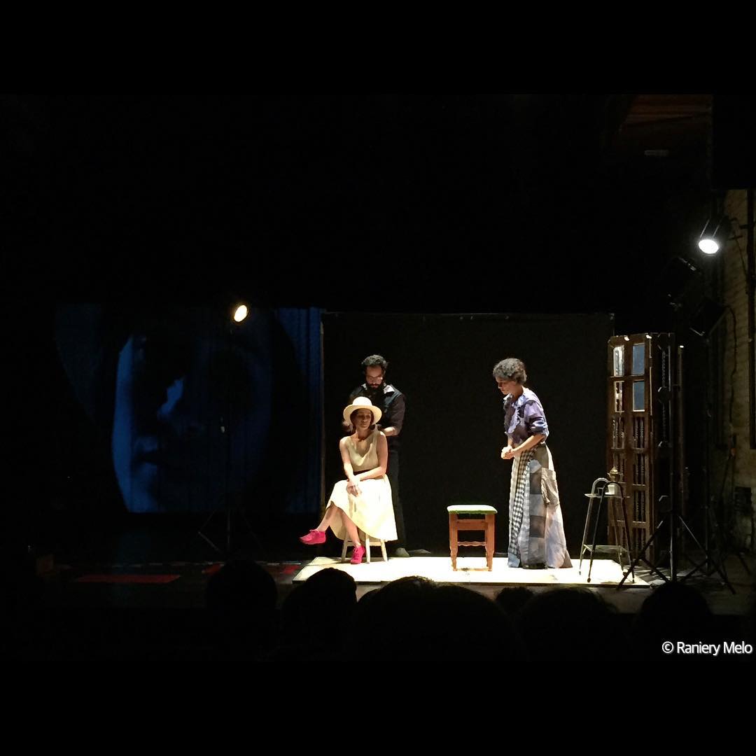 people on stage at a play in the dark