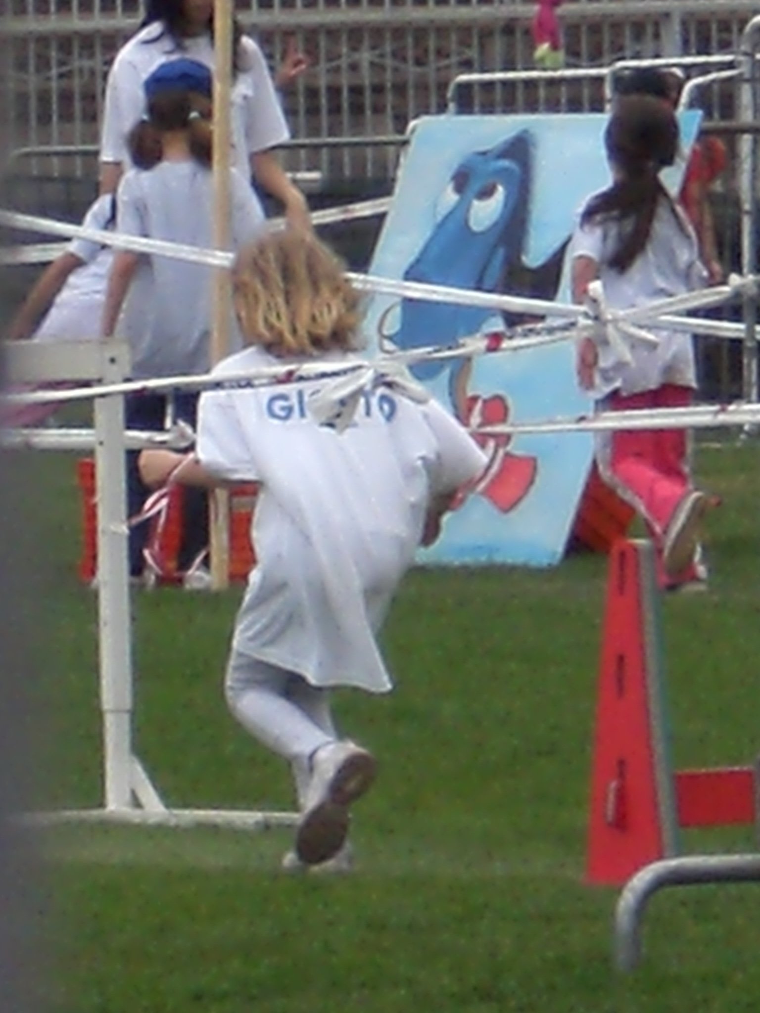 the young soccer player is jumping off of a pole