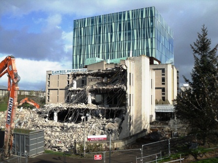 an excavating machine is on the side of the building