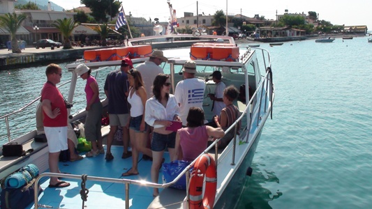 many people are standing on the boat in the water