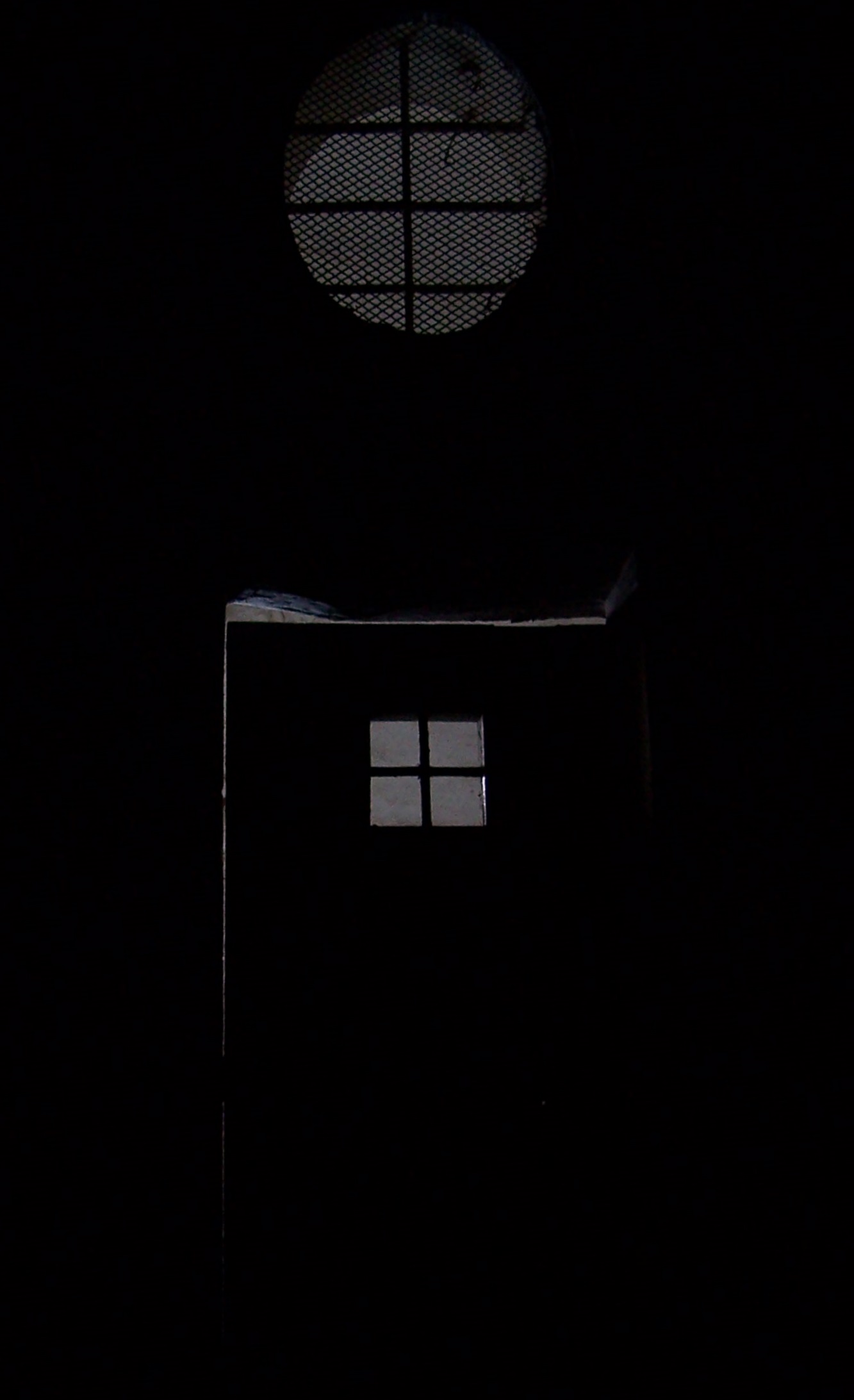 the back wall of a house, lit up by the darkness