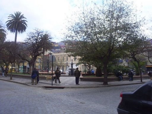 many people walking around an old city plaza