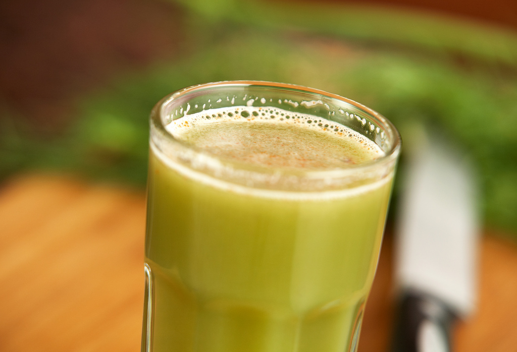 a juice is sitting in a glass on a table