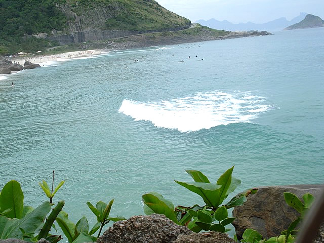 a boat is in the ocean near some rocks