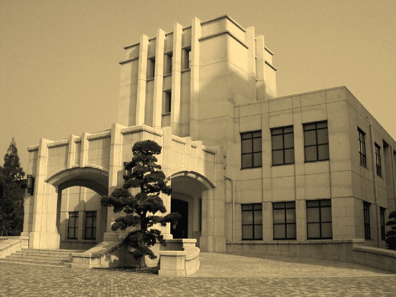 a large building with an entry way and trees in front of it