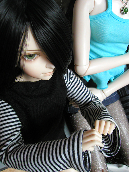 a doll sits next to a female doll