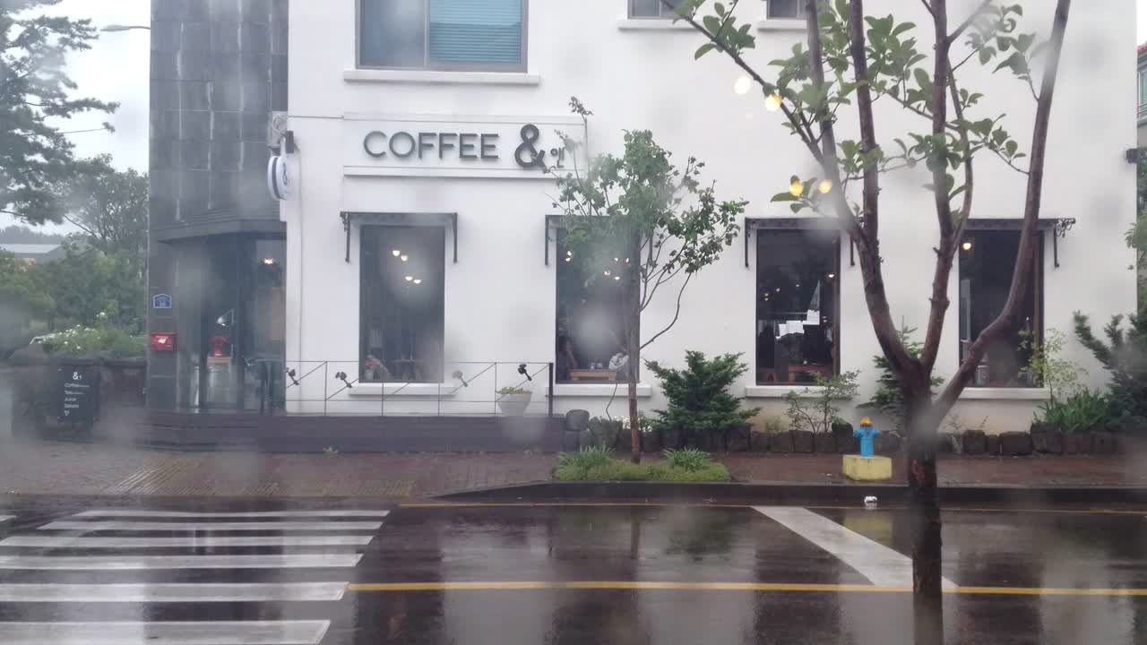 a tall white coffee shop sitting on the side of a road