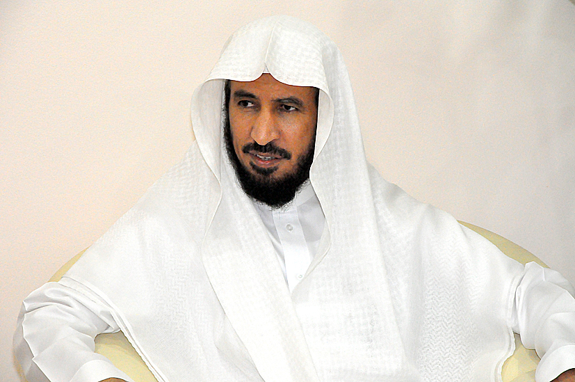 a middle eastern man sitting down in a white robe