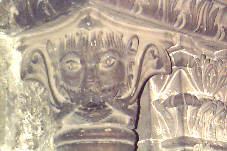 an old carving showing a face and head