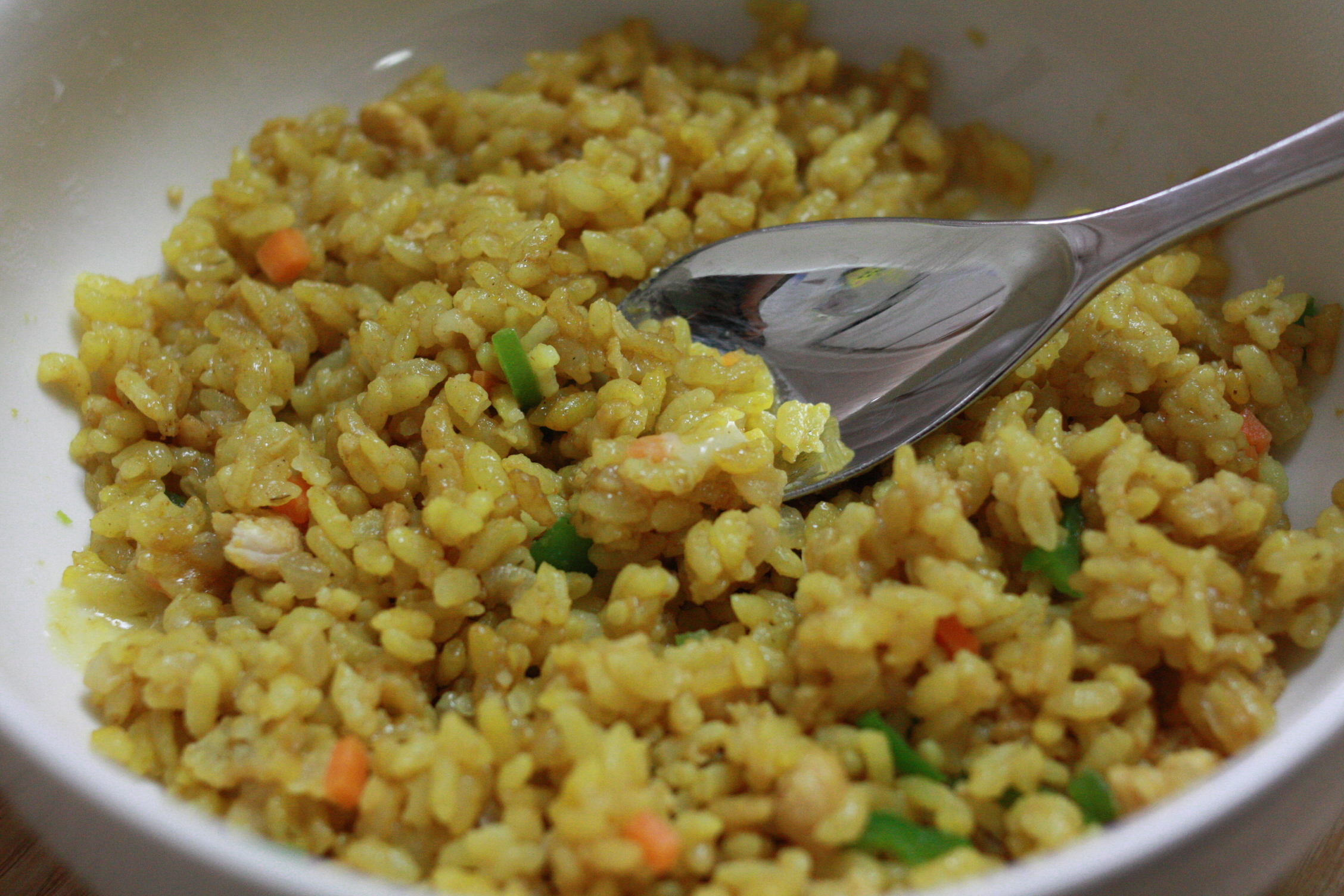 a bowl filled with rice with some green onions