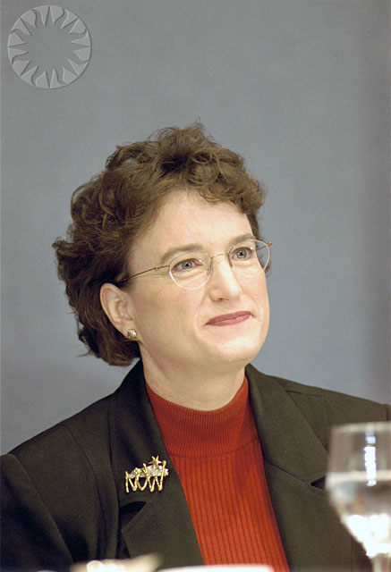 a woman with a suit and red sweater
