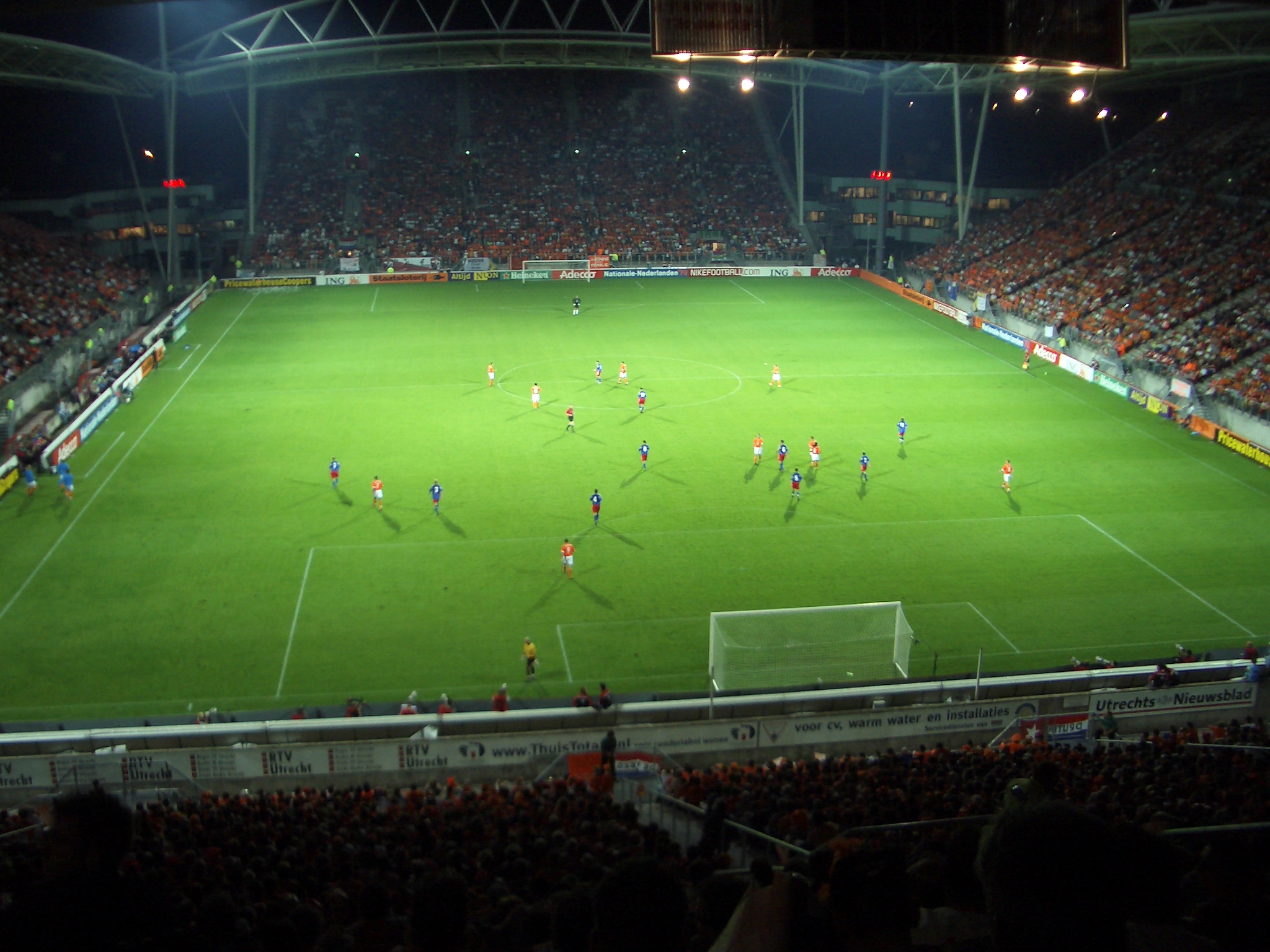 group of people playing soccer in the dark