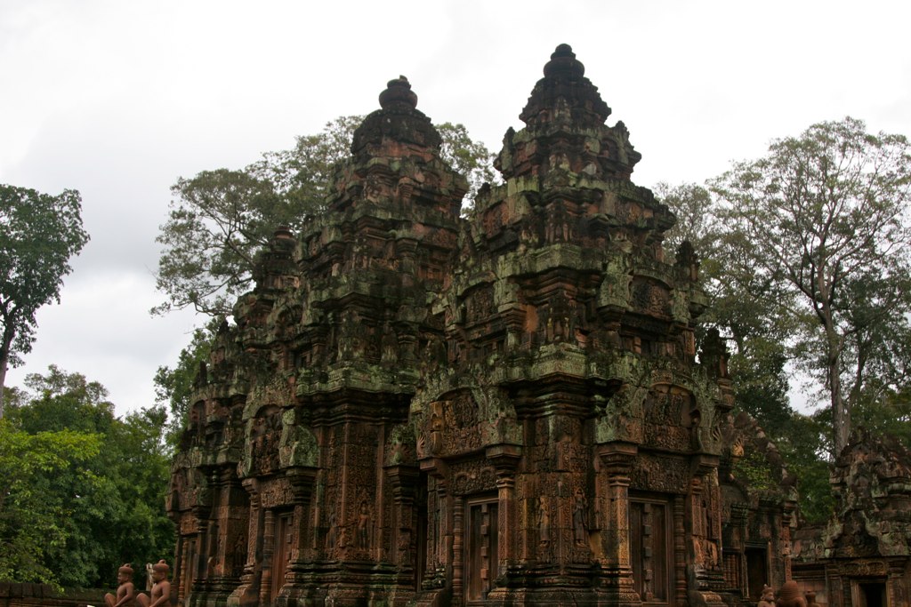 some very old towers in the middle of a park