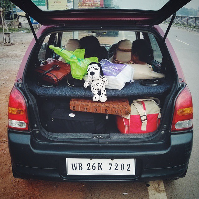 the car has many suitcases and bags in the back