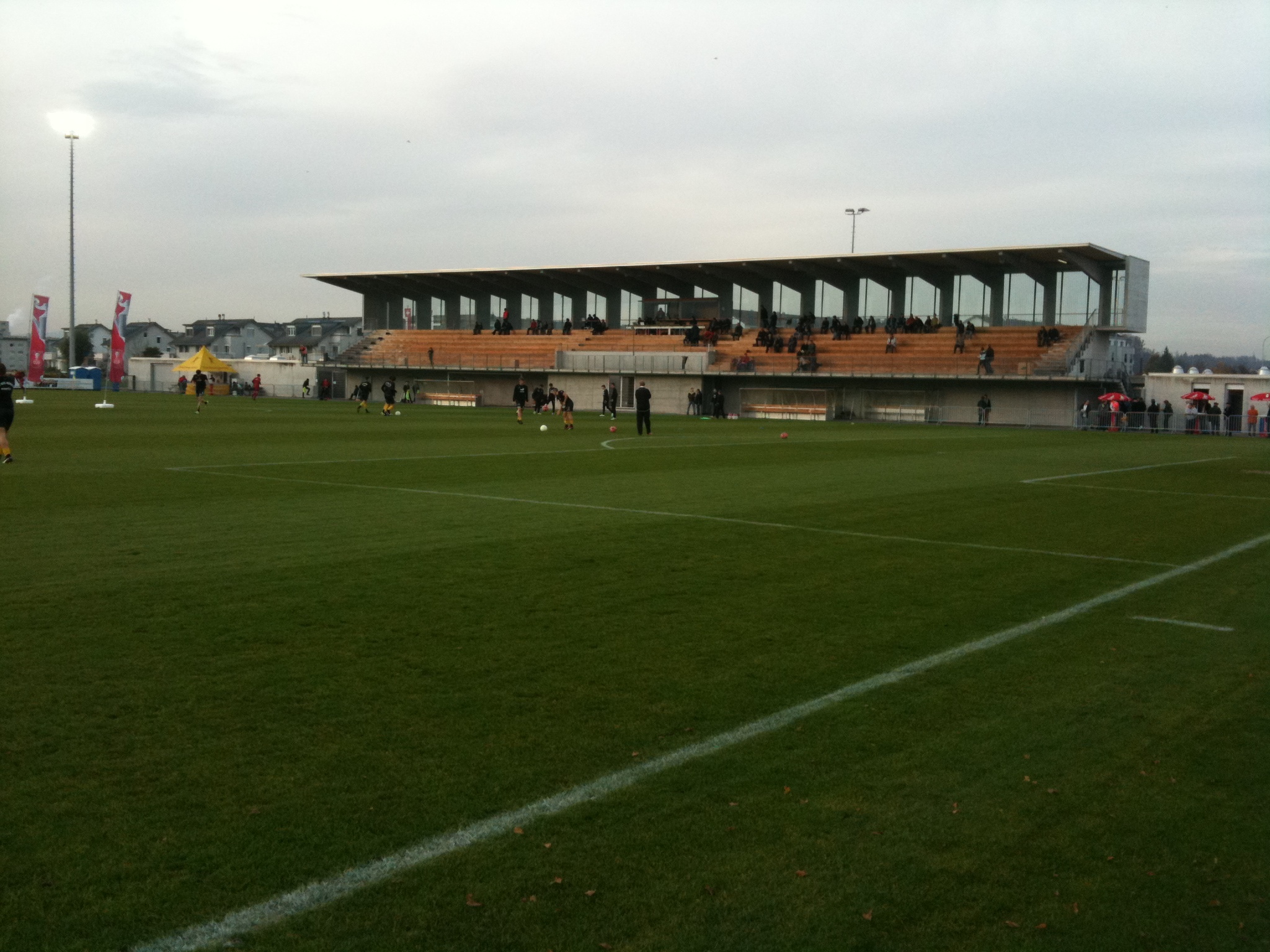 players practice on the grass on a cold, foggy day