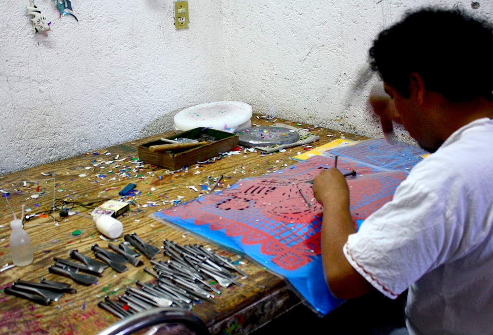 man at a workbench working on an artwork project