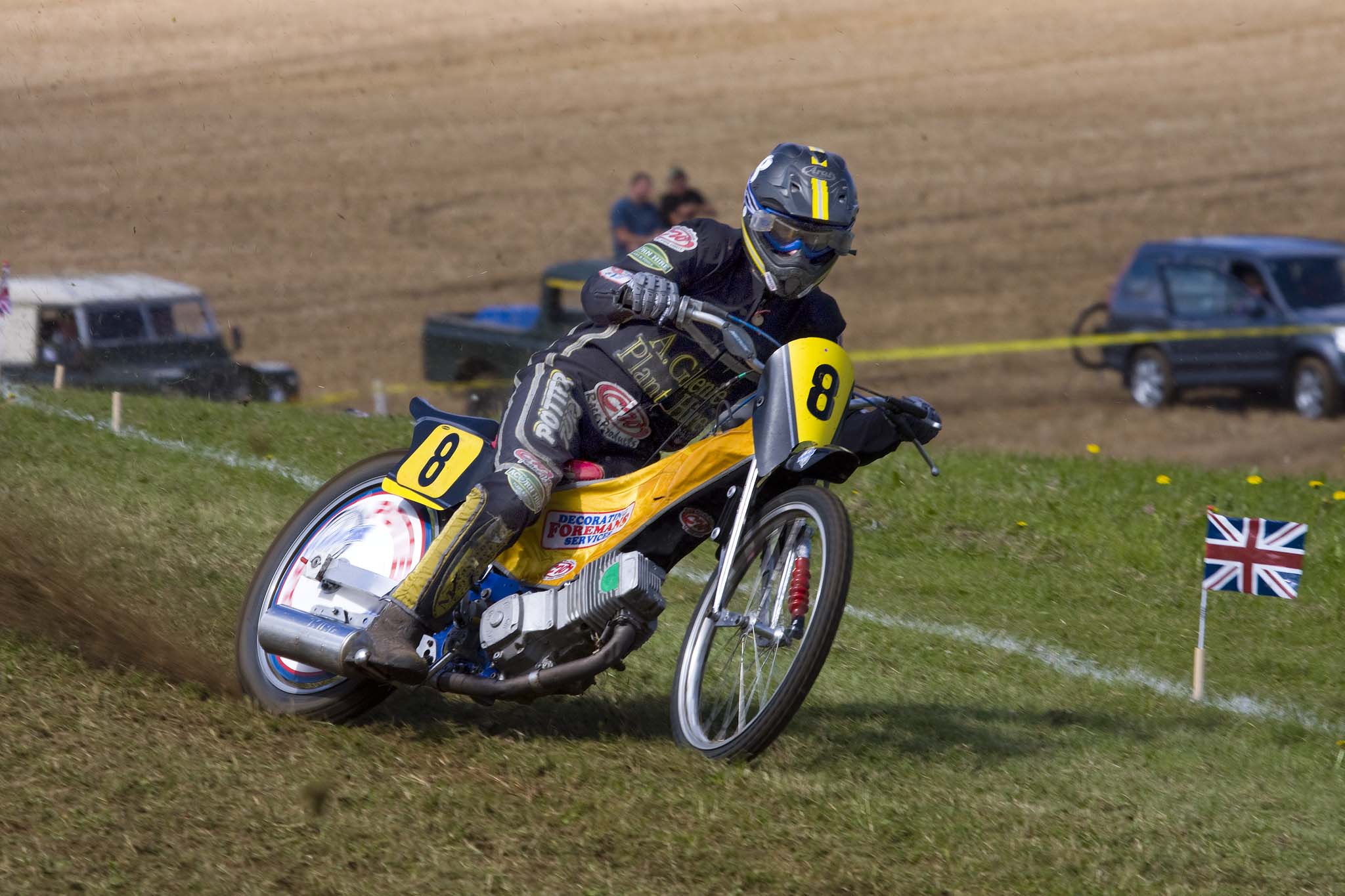 an image of a man riding a motorcycle around a corner