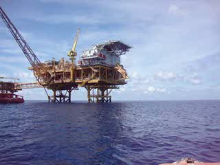 an offshore drilling platform in the middle of the ocean