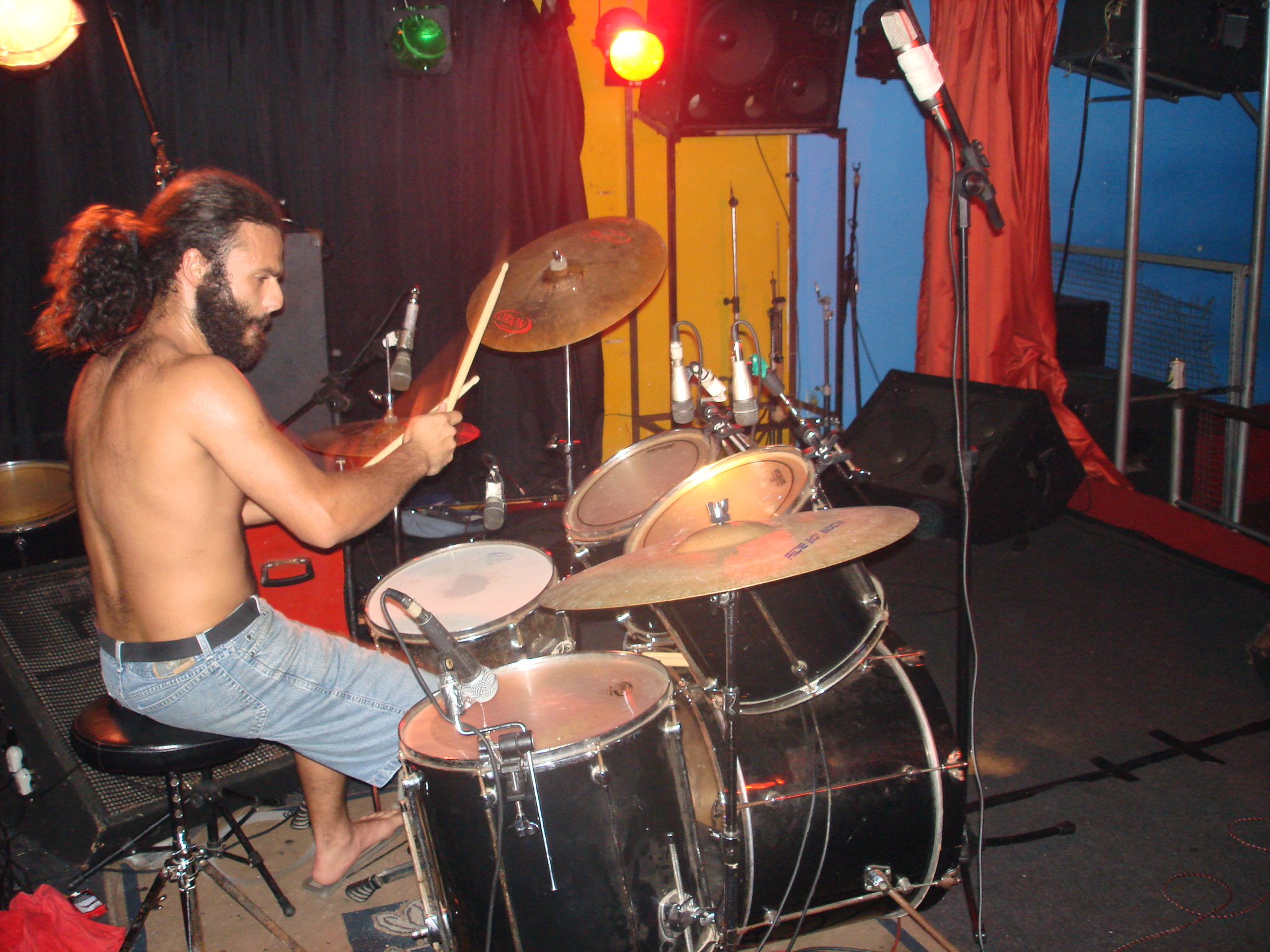 a man plays drums inside a music studio