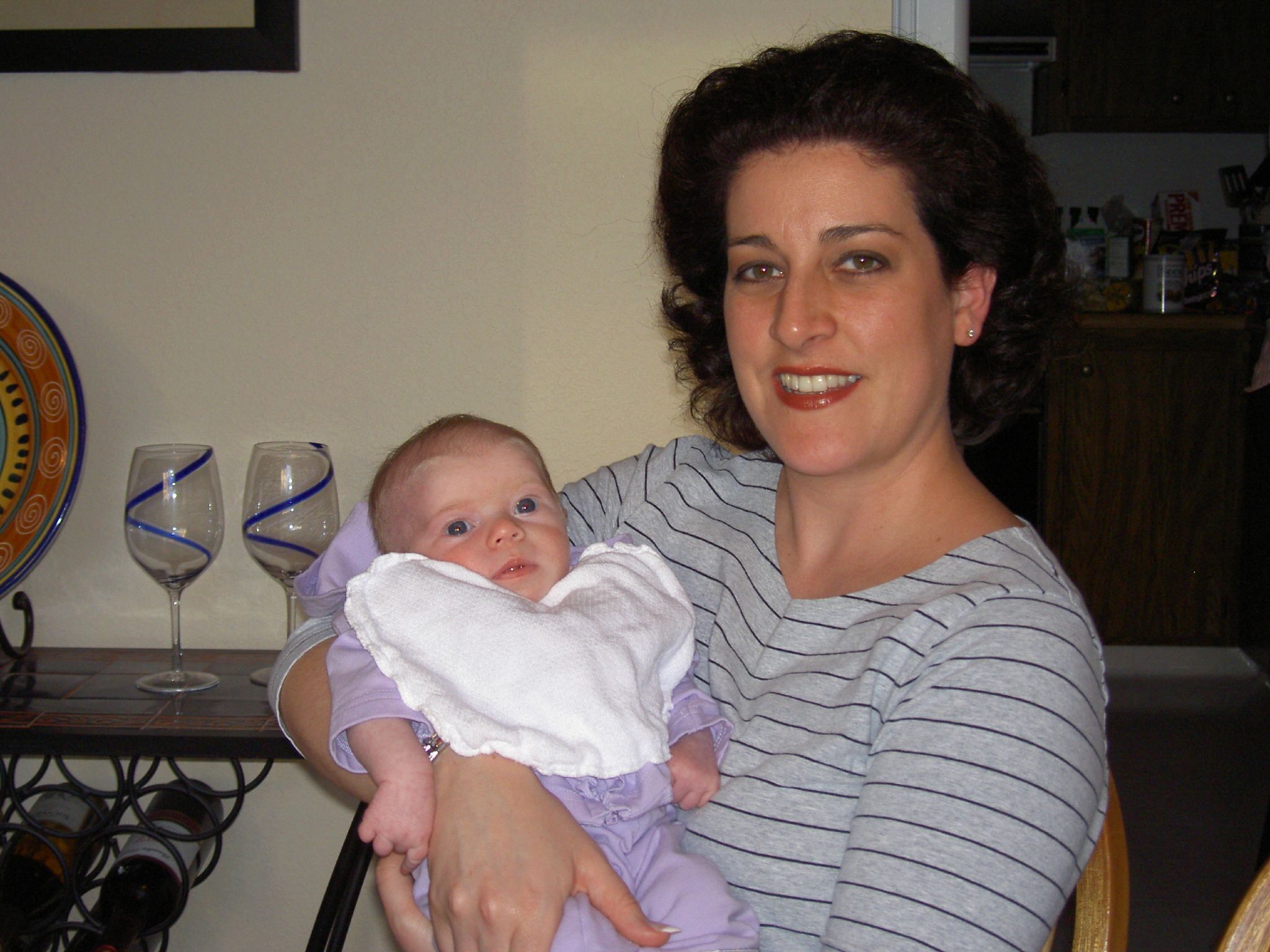 woman holding up her baby girl for the camera