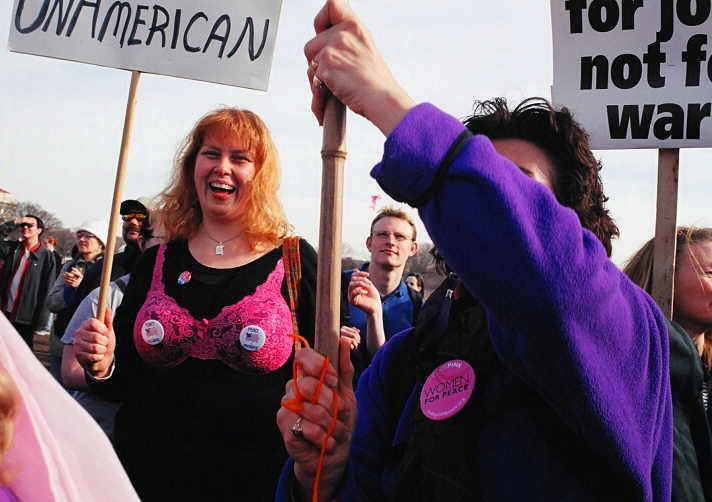 a woman has her hand up in protest