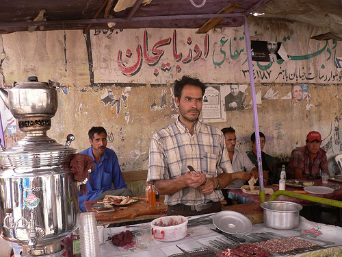 a man standing at a counter with bowls of food