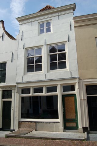 a building with boarded windows on a city street