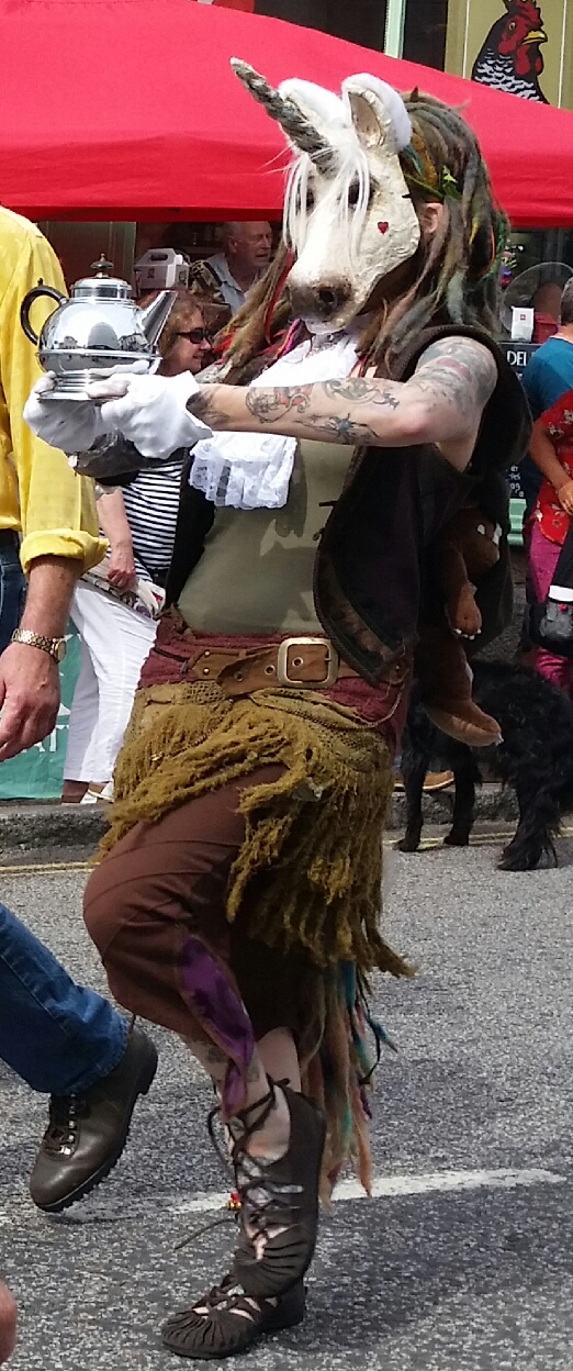 a man dancing on the street wearing some fancy costume