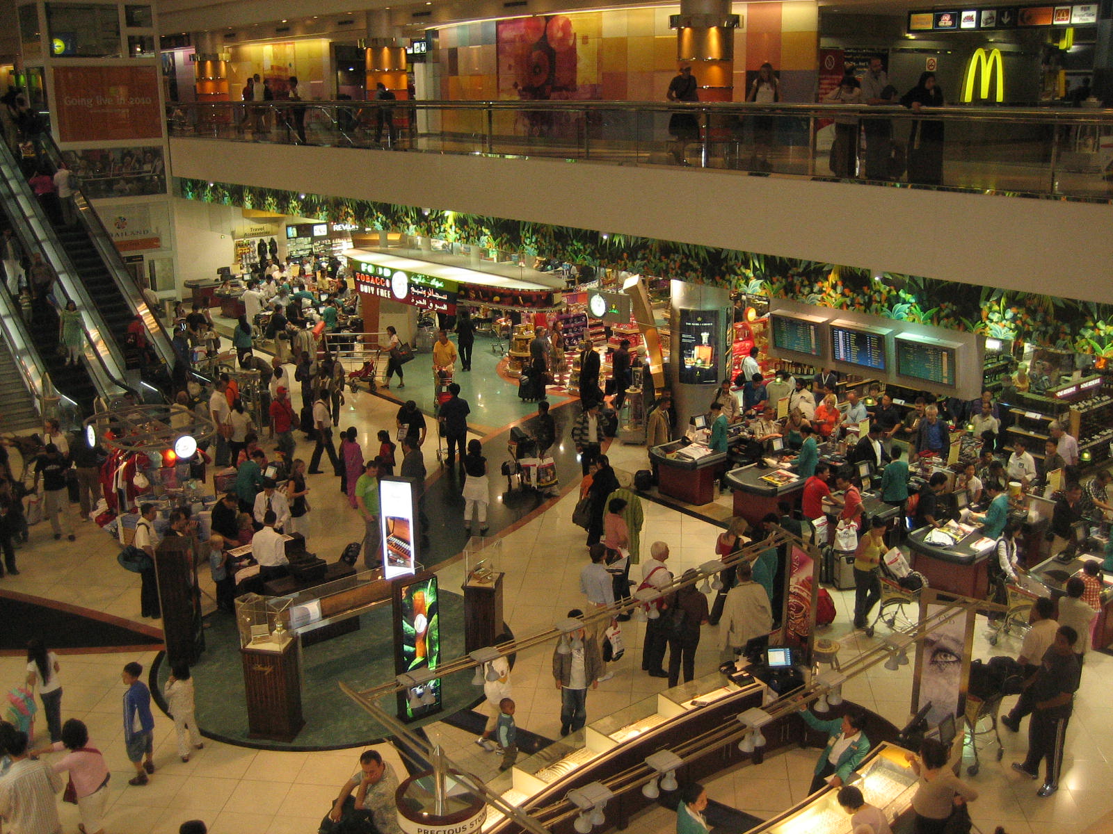 a crowded mall at night time with lots of people