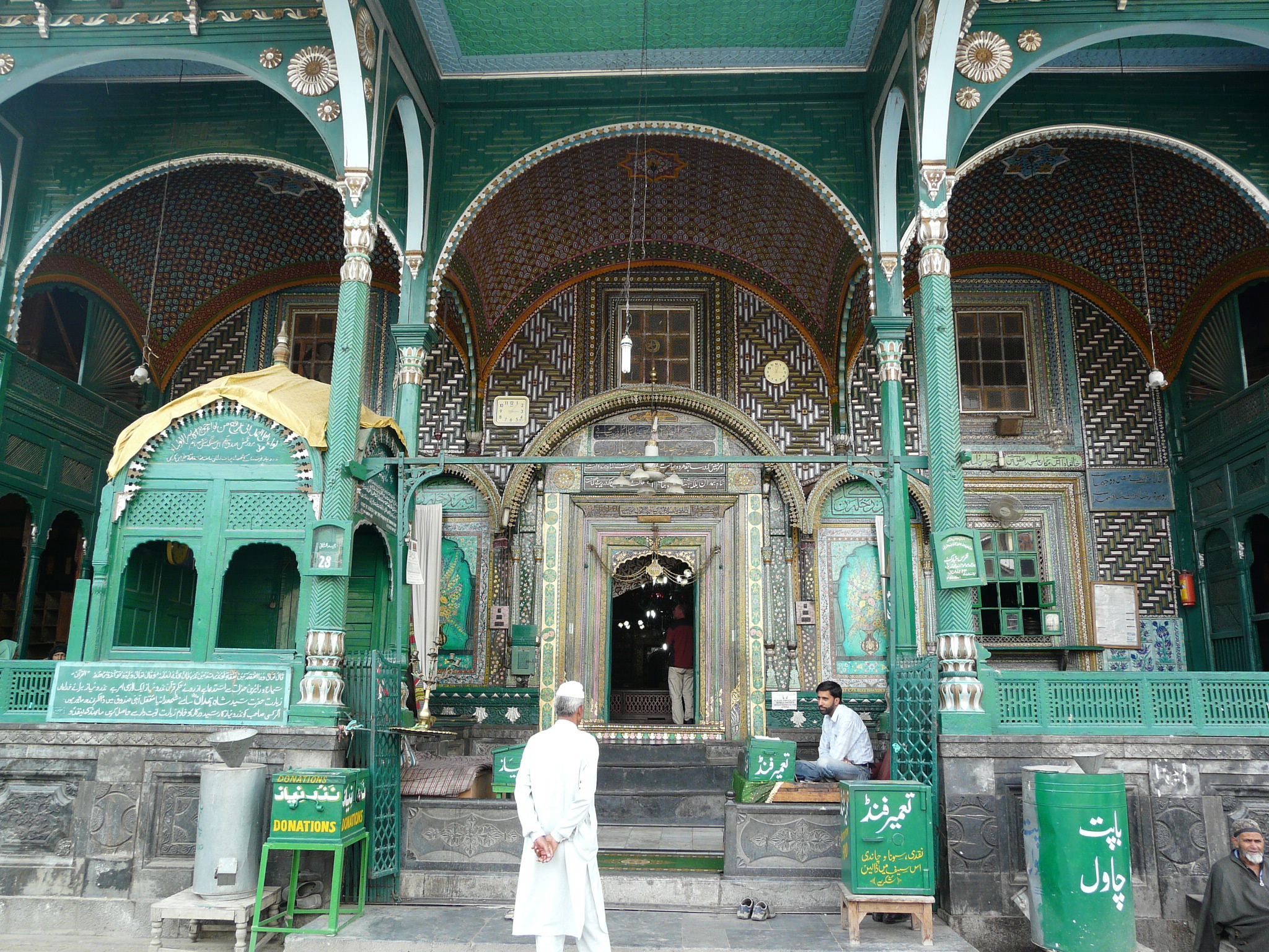 two people standing in front of a mosque