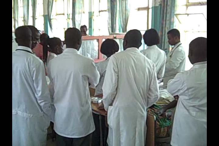 several doctors wearing white in a large room