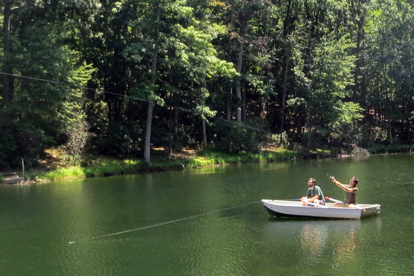 a couple is sitting in the water on a small boat