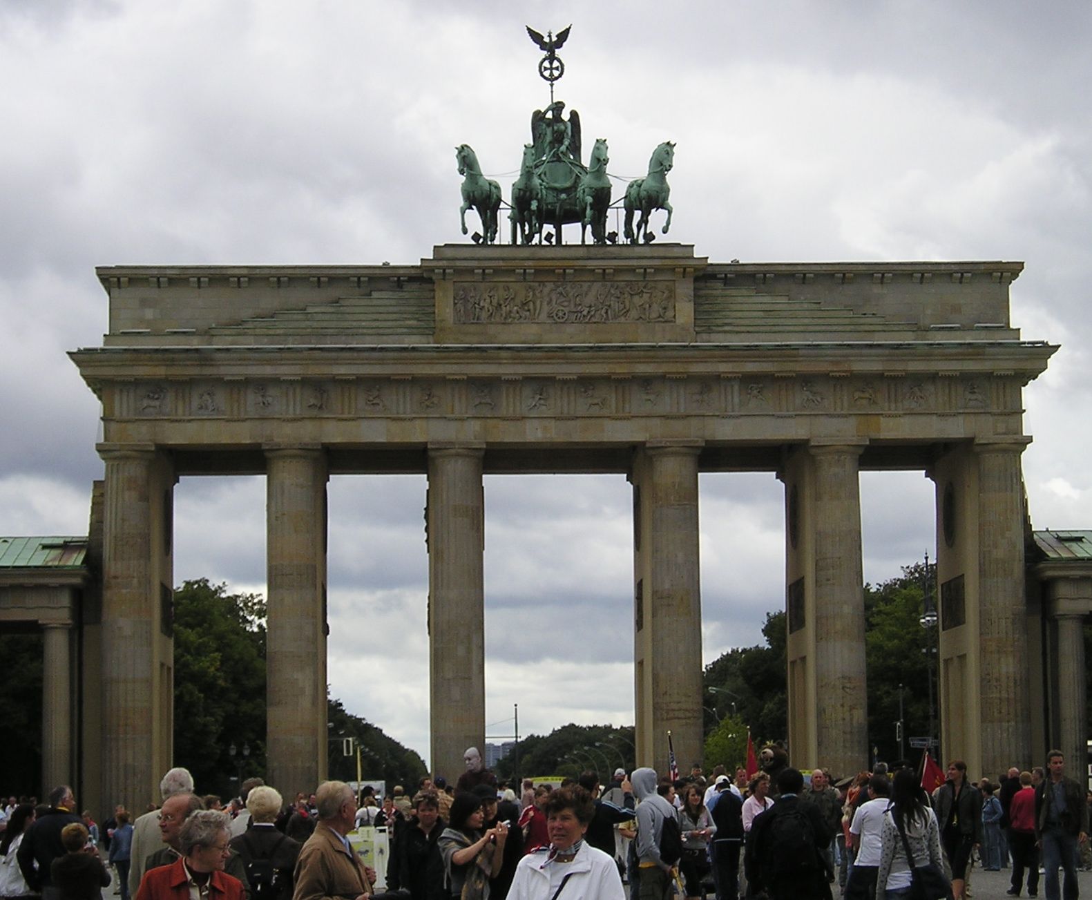 a crowd of people standing around in front of a monument