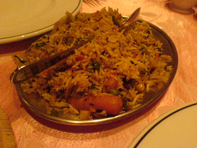 rice with sausage is in the middle of a plate