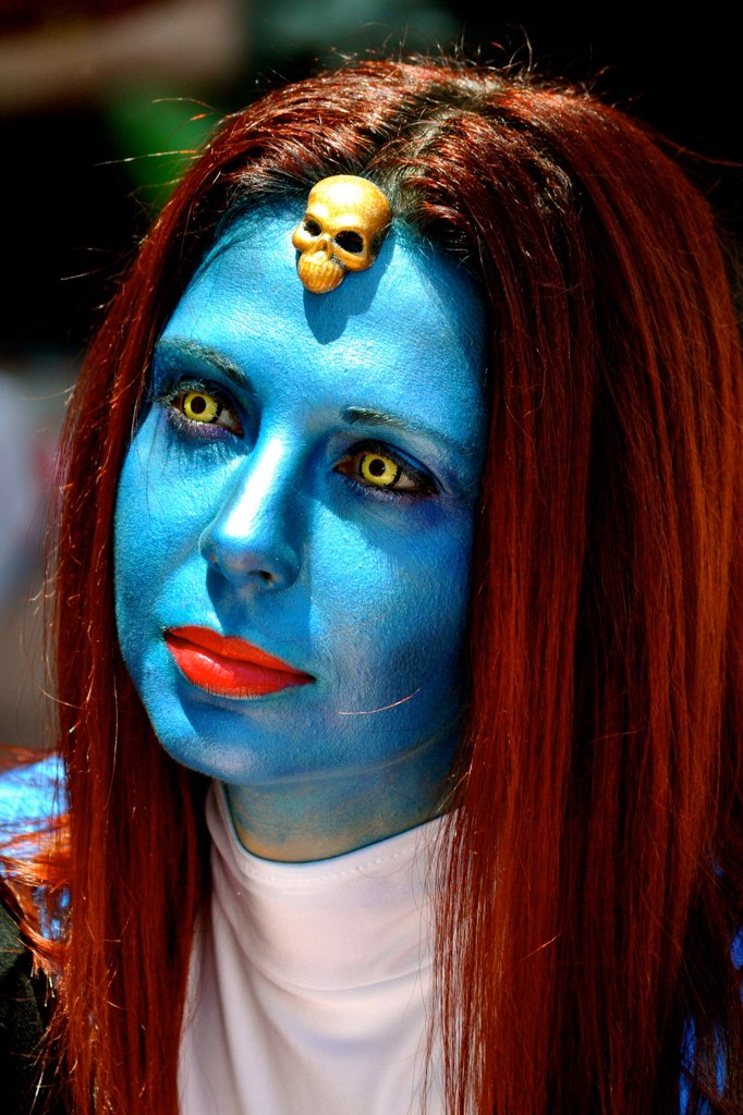a woman with blue makeup painted on her face and lips