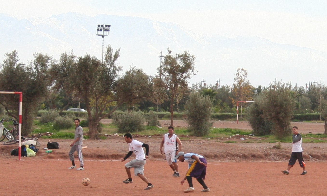 soccer players practice their moves as the ball drisbees past