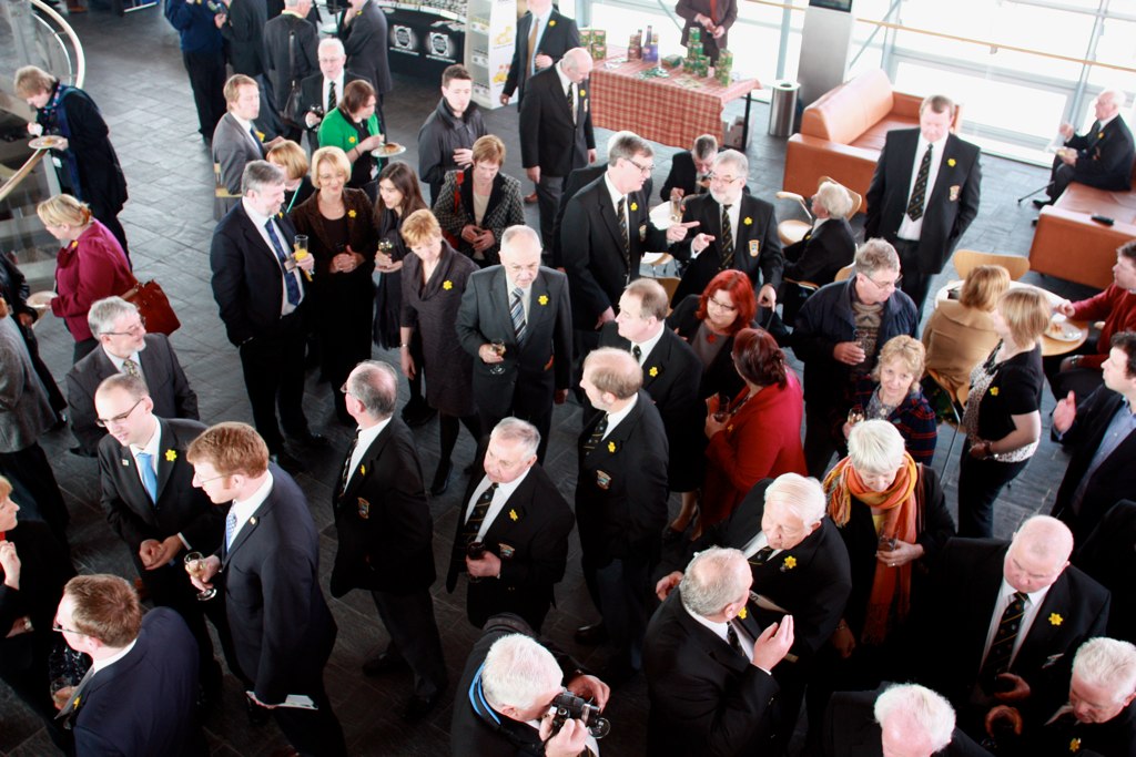 a large crowd of people who are dressed in black suits