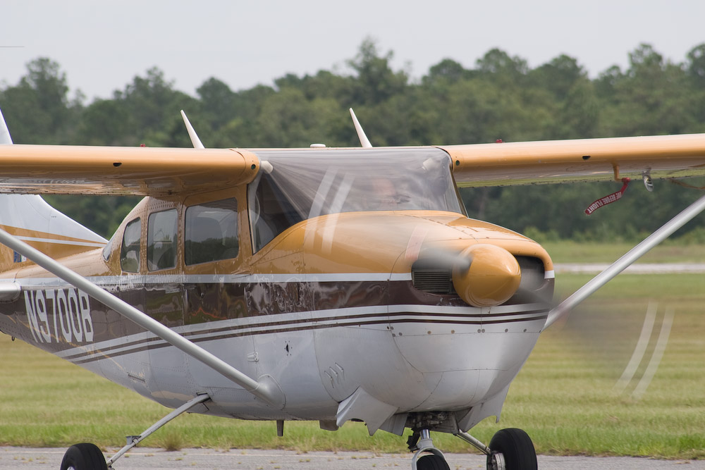 the small plane is white, brown and black