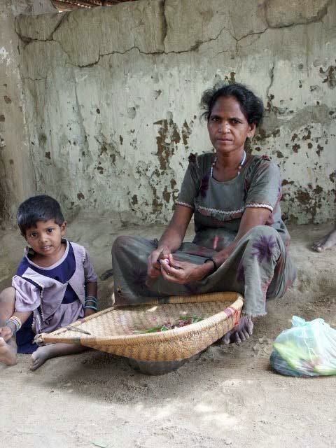 a woman sitting with her child in front of a basket