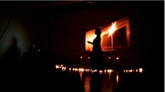 a person is silhouetted against the backdrop of a dark room