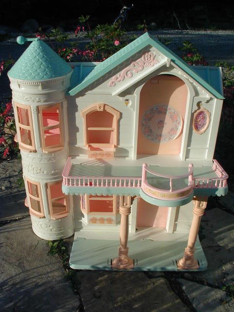 an old wooden doll house sitting on top of some bricks
