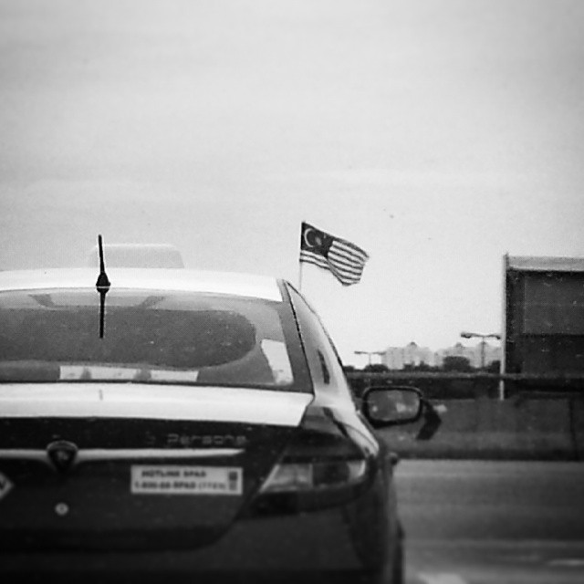 a car with an american flag flying from the top of it