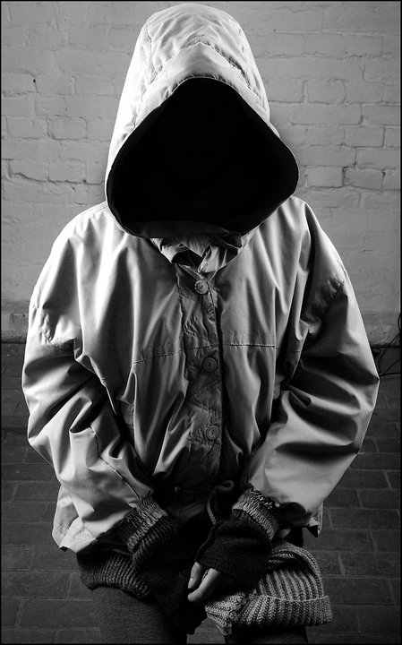 black and white pograph of a person wearing a hoodie