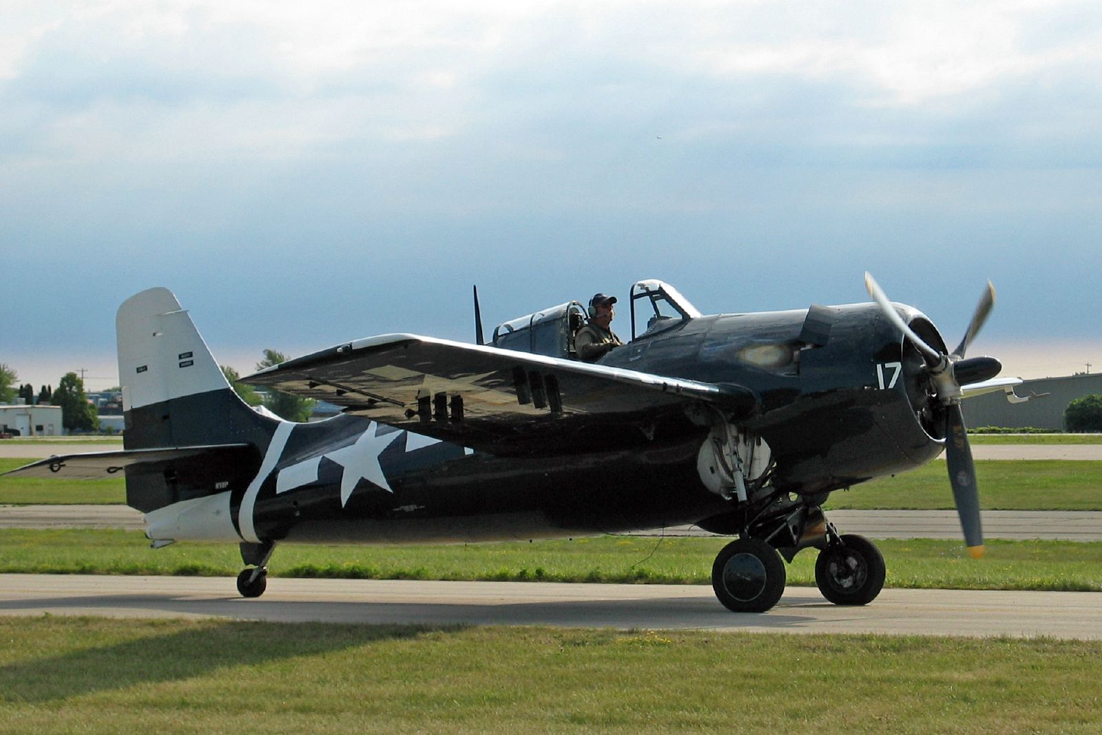 an old military airplane is parked on the runway