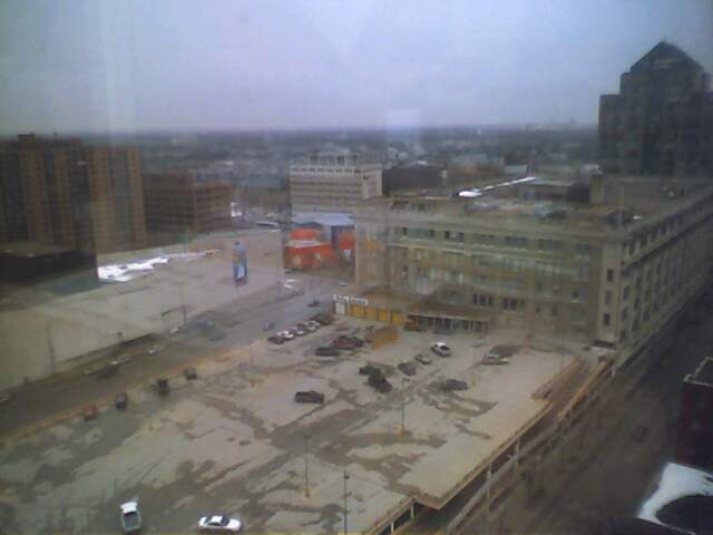 the po is taken from an elevated view looking down onto a parking lot and buildings