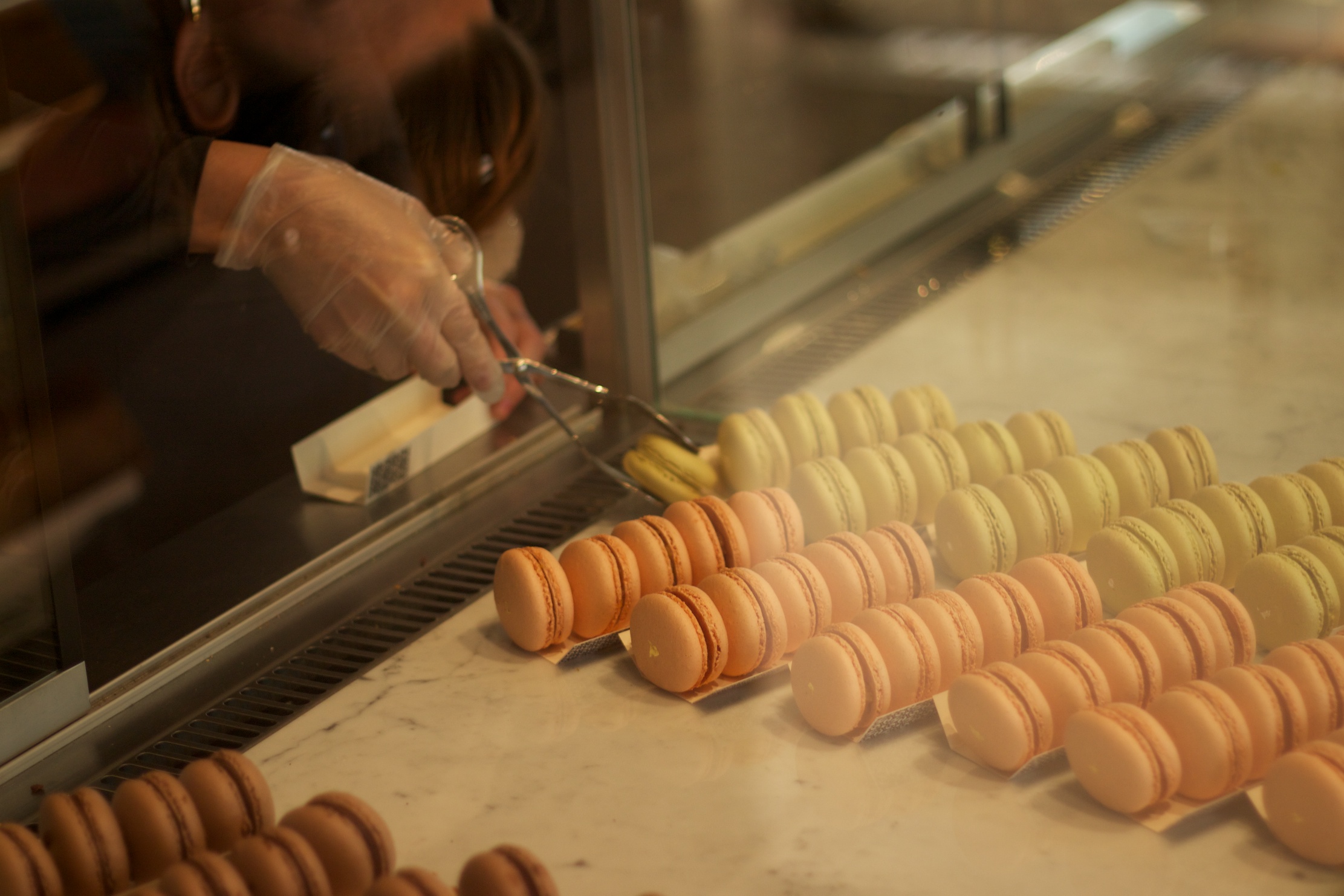 a woman preparing food in a line under a window